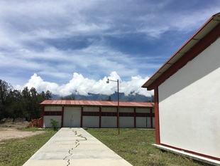 Mountaintops rise behind the school's campus.